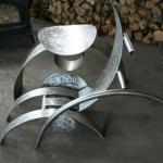 Le relax a la turbine 
Sculpture réalisé par Denis Poirier , 2005-2007.
Acier Inoxydable, 
Ensemble en trois partie, chaise qui n’est pas une chaise et d’une table qui n’est pas une table, agencer d’une roue suspendu, la turbine. 
15000$
