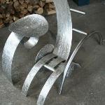 Le relax a la turbine 
Sculpture réalisé par Denis Poirier , 2005-2007.
Acier Inoxydable, 
Ensemble en trois partie, chaise qui n’est pas une chaise et d’une table qui n’est pas une table, agencer d’une roue suspendu, la turbine. 
15000$